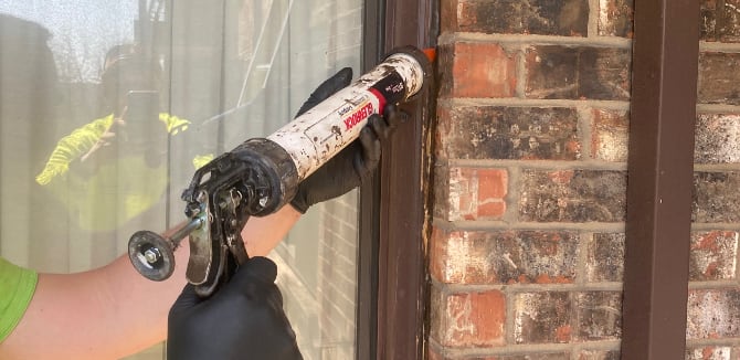 Caulking around window frame for weatherproofing